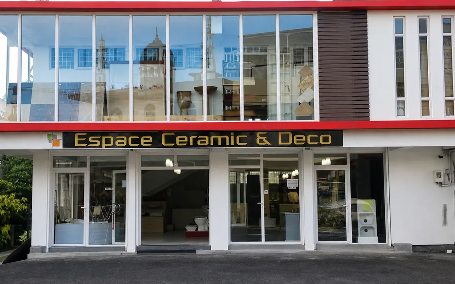 The Espace Ceramic and Deco showroom on Curepipe Road, a two storey glass frontage under the gold on black shop sign.